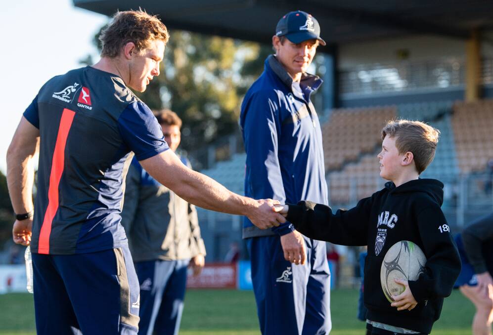 MEET AND GREET: Wallabies captain Michael Hooper shakes hands with a Maitland junior at a clinic at Cessnock Sportsground on Monday. The Wallabies are spending four days in camp in Cessnock. Picture: Rugby Australia 