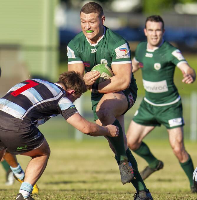 FULL STEAM: Merewether centre Bill Coffey charges into the Nelson Bay defence in the Green's 48-3 rout over the Gropers at Hawkins Oval. Picture: Stewart Hazell 