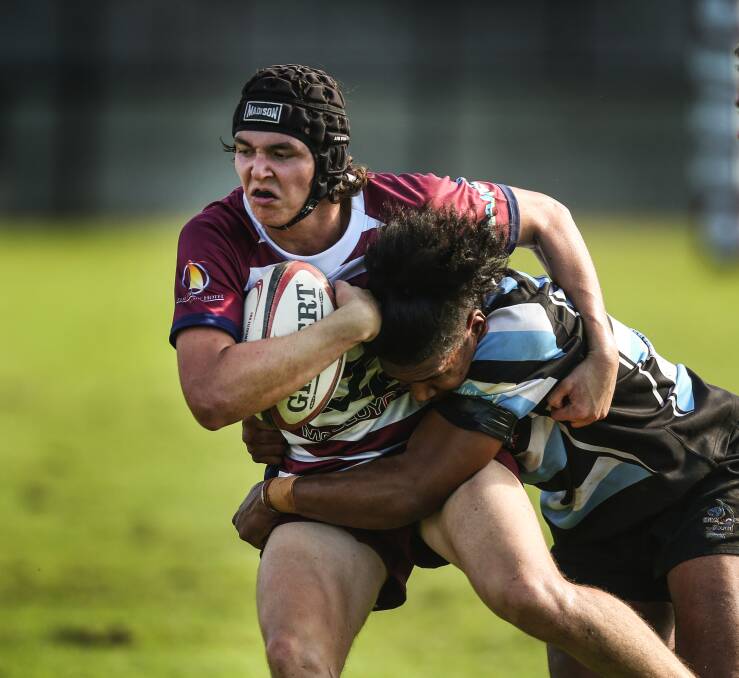QUICK LEARNER: University fullback Brady Mather tries to break through a tackle against Nelson Bay. The Inverell teenager is one of two Uni players in the NSW Country Colts squad. Picture: Marina Neil