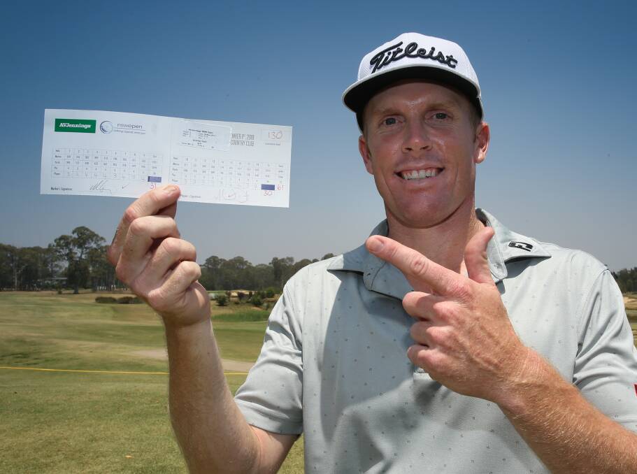 RECORD BREAKER: Andrew Dodt shows off his scorecard after setting a new course record on the way to grabbing the lead at the midpoint of the NSW Open at Twin Creeks Country Club. Picture: David Tease (Golf NSW)