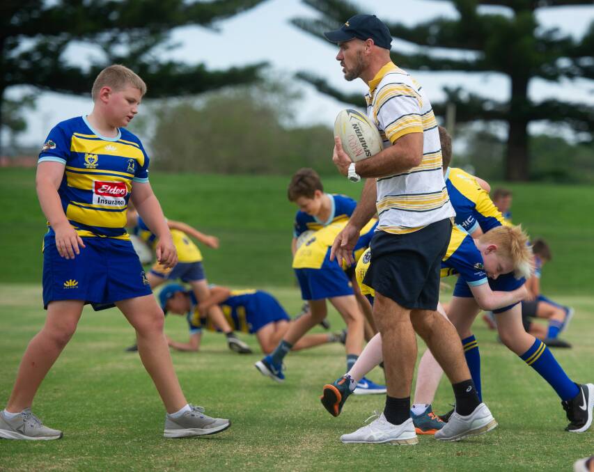 FUTURE STARS: Classic Wallaby Nathan Grey puts Hunter juniors through their paces at a coaching clinic at No.2 Sportsground on Friday. Picture: Marina Neil 