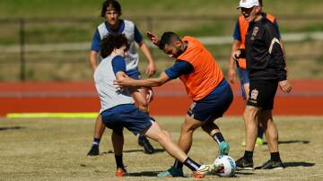 HARD YARDS: Mark Natta and Mo Al-Taay compete for the ball at Jets training. Picture: Jonathan Carroll