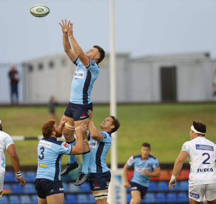 ON THE RISE: Harry Johnson-Holmes (left) and Michael Hooper lift Jack Dempsey in a lineout in the Waratahs' 32-12 loss to the Blues. Picture: Jonathan Carroll