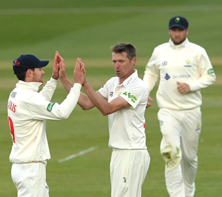 PRIZED SCALP: Glamorgan quick Michael Hogan is congratulated by James Harris after taking the wicket of England captain Ben Stokes in the County Championships clash at the Riverside. Picture: Stu Forster