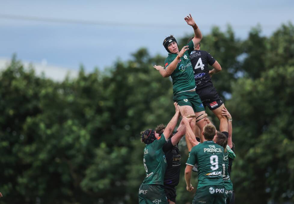 Merewether lock Tom Jackson flies high at a lineout. Picture by Marina Neil