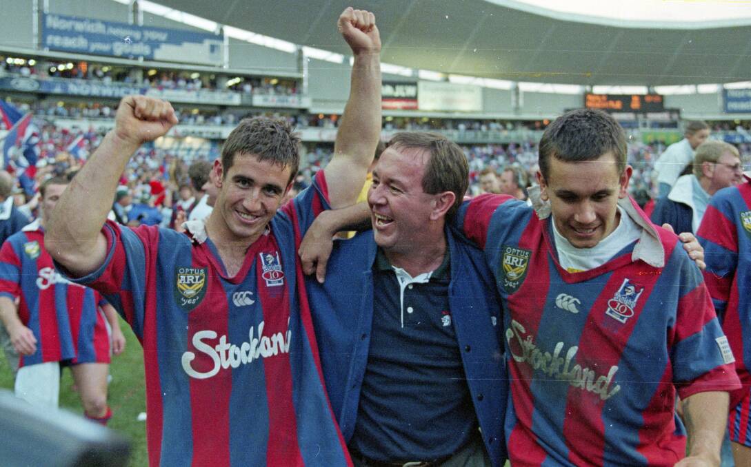 ON TOP: Andrew Johns, his dad, Gary, and brother Matthew after the Knights' history-making grand-final triumph over Manly in 1997. 