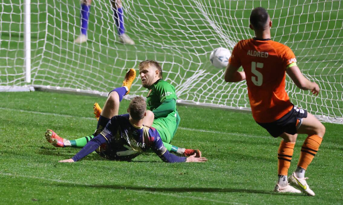 Trent Buhagiar watches his shot crash into the back of the net for the first goal in the Jets' with Brisbane Roar in the Australia Cup clash at Maitland Sportsground on Monday night. Picture Getty Images 