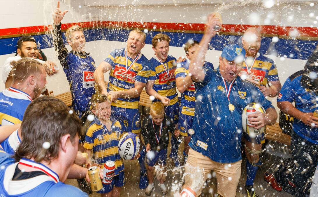 BEER SHOWER: Coach Scott Coleman leads the Hawks' celebrations after the 36-7 win over Wanderers in the grand final on Saturday. Pictures: Max Mason-Hubers
