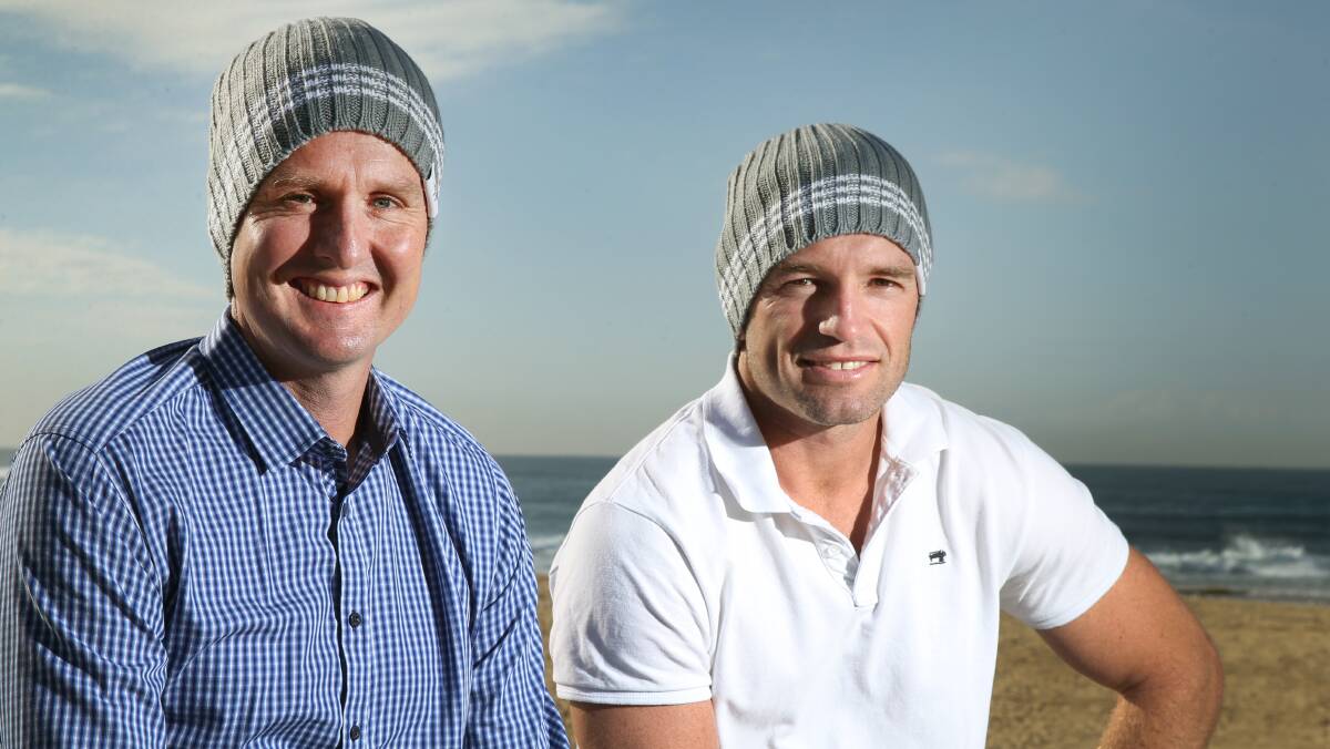 GOOD LOOK: Mark Hughes and Danny Buderus model beanies being sold to raise money for brain cancer research. Pictures: Marina Neil