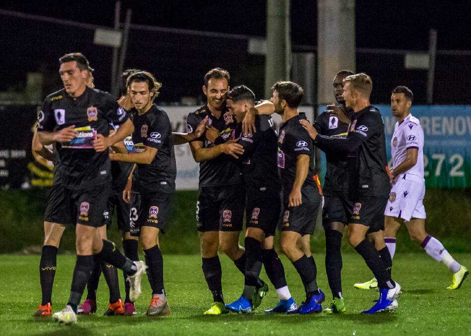 DYNAMIC DUO: Ben Kantarovski and Dimi Petratos (centre) celebrate after combing for the Jets' opening goal against the Perth Glory in the Gold Coast on Tuesday night. Picture: Paul Smith