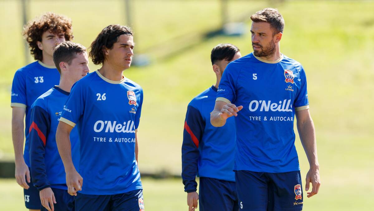 Newcastle Jets captain matt Jurman (right) makes a point at training. Picture by Max Mason-Hubers