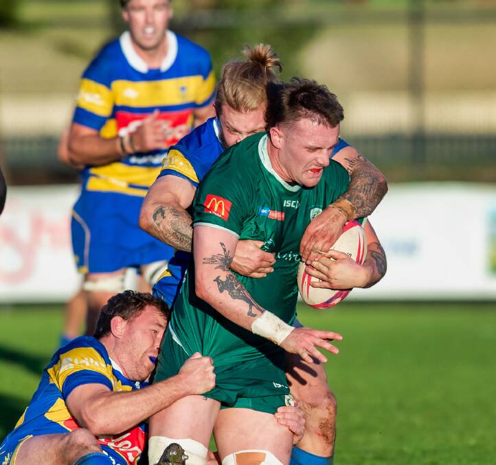 Merewether lock Kade Robinson powers through a Hamilton tackle in the Greens' 28-26 win in the major semi-final. Picture by Stewart Hazell