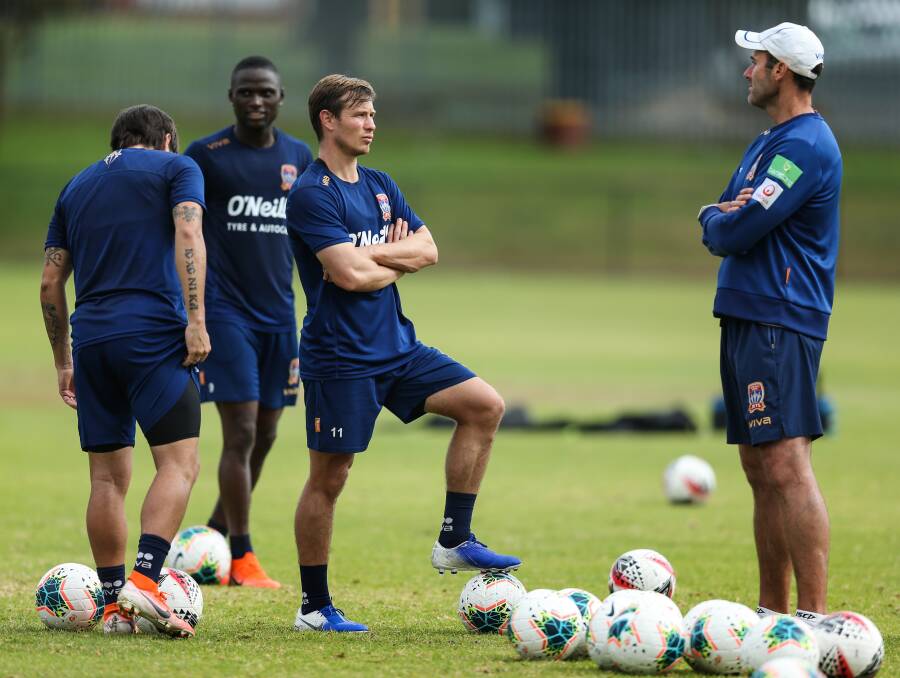 HIGH HOPES: Nick Fitzgerald (second from right) talks to assistant coach Clayton Zane at training. Picture: Marina Neil
