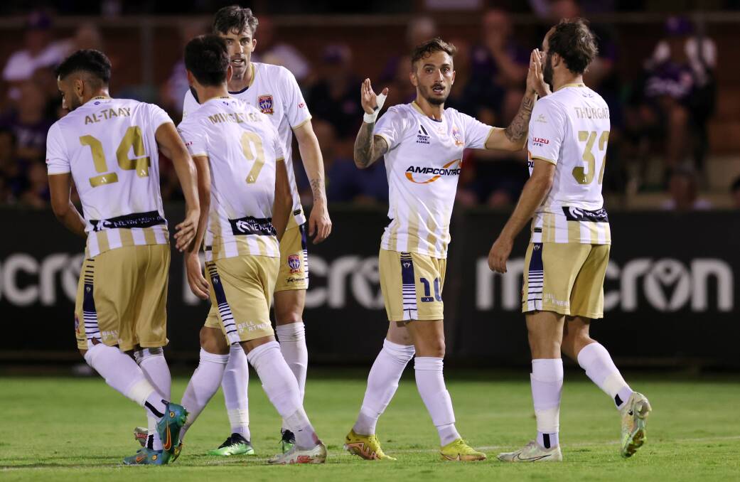 Angus Thurgate congratulates Reno Piscopo after the midfielder scored a spectacular goal in the Jets' 2-all draw with Perth Glory on Saturday night. Picture Getty Images