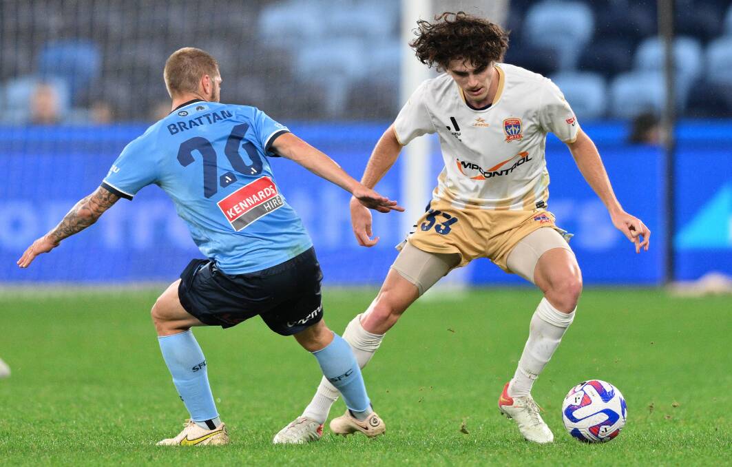 Newcastle defender Mark Natta competes with Sydney midfielder Nathan Brattan for possession in the Jets' 2-0 loss to the Sky Blues at Allianz Stadium on Saturday night. Picture by Izhar Khan, Getty Images