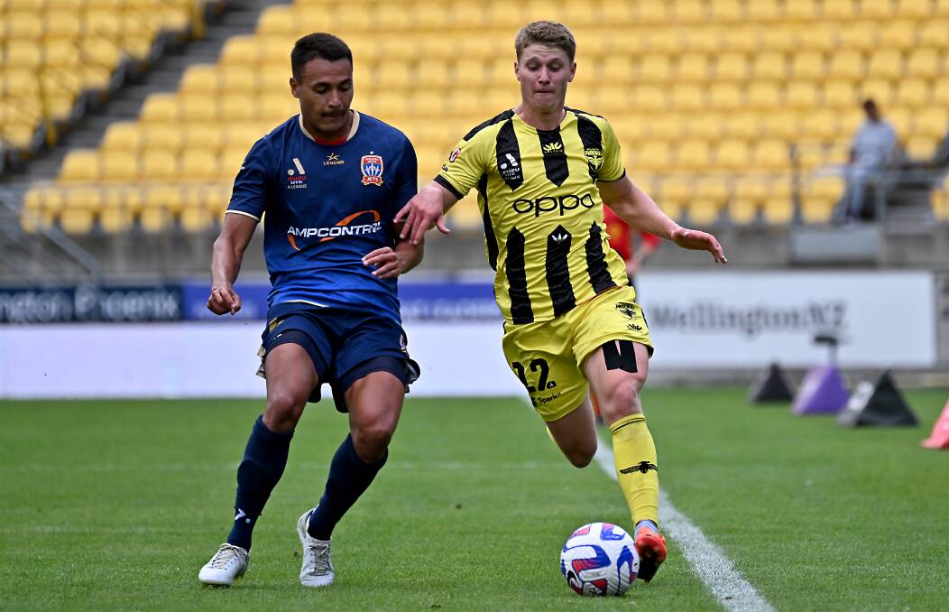 Newcastle defender Dane Ingham goes in to make a tackle on Lucas Mauragis in the Jets' controversial 2-1 loss to Wellington on Saturday. Picture Getty Images 