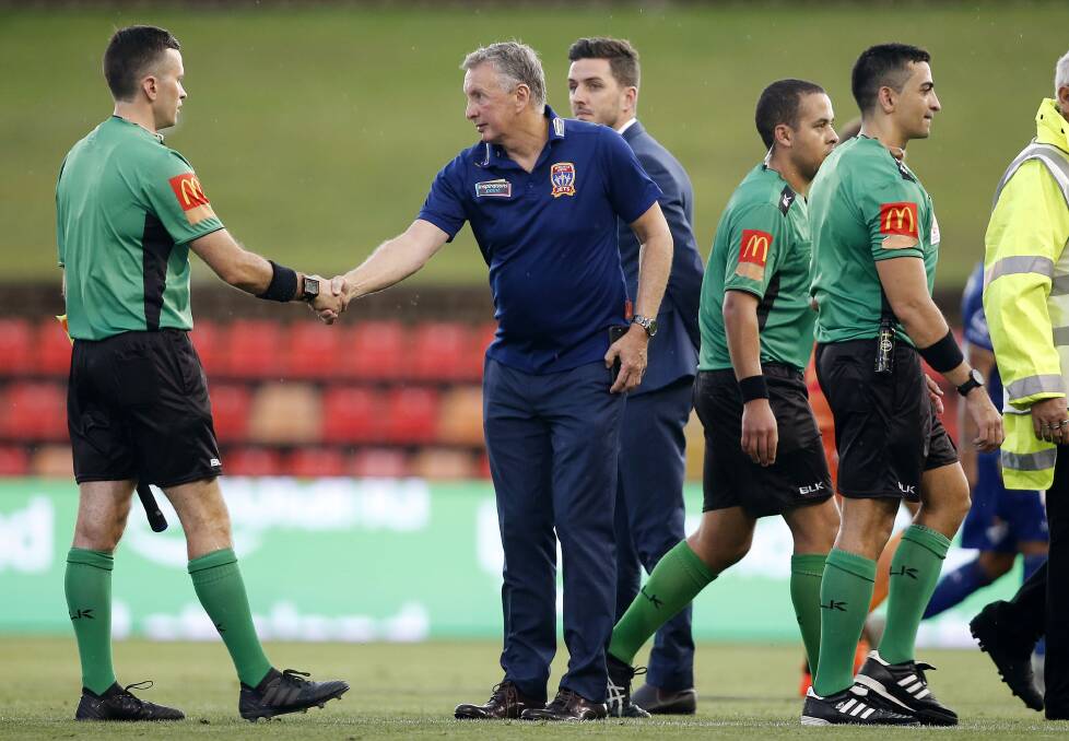 GOOD RELATIONSHIP: Jets coach Ernie Merrick shakes the hands of match officials after the Jets' 2-0 loss to Perth in round eight. The veteran mentor maintains he gets on well with the majority of referees. Picture: AAP