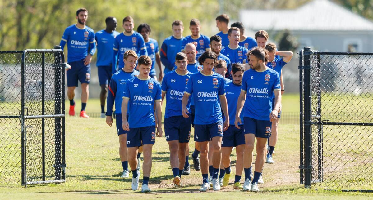 Newcastle Jets file out onto the training pitch at Maitland Sportsground. Picture by Max Mason-Hubers