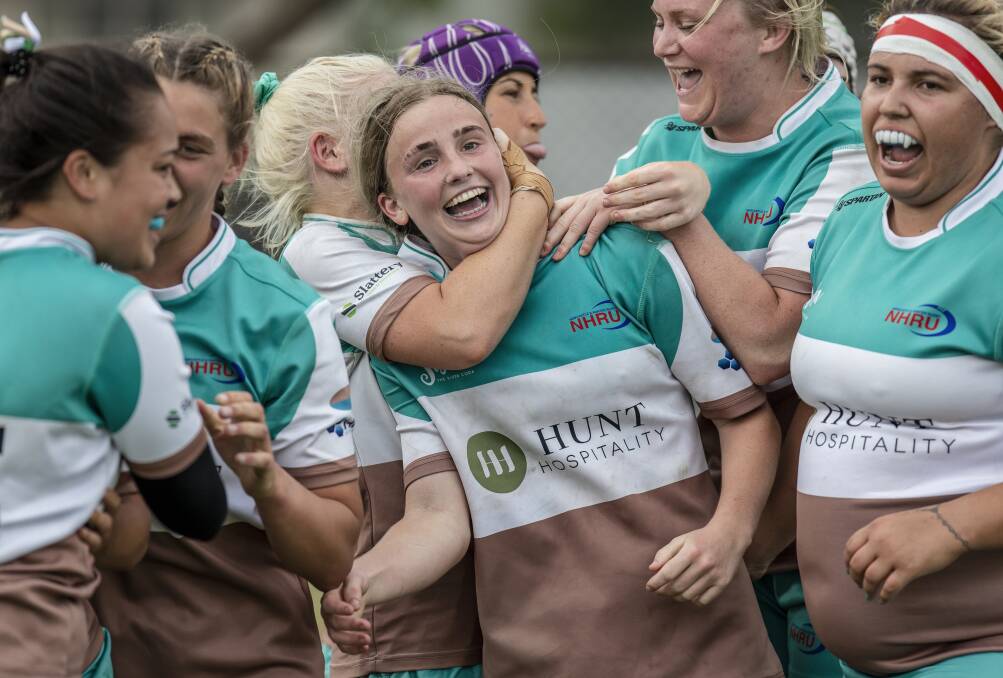 ALL SMILES: Sophie Clancy (centre) and her Hunter Wildfires teammates celebrate after their hard-fought 29-24 triumph over Campbelltown in the Jack Scott Cup division two grand final. Picture: Stewart Hazell