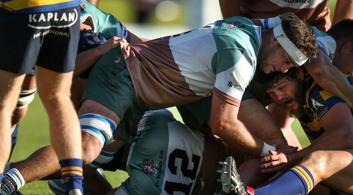 HARD YARDS: Hunter Wildfires lock Adam Edwards provides protection for the ball at a ruck during the loss to Sydney University at No.2 Sportsground. Picture: Stewart Hazell