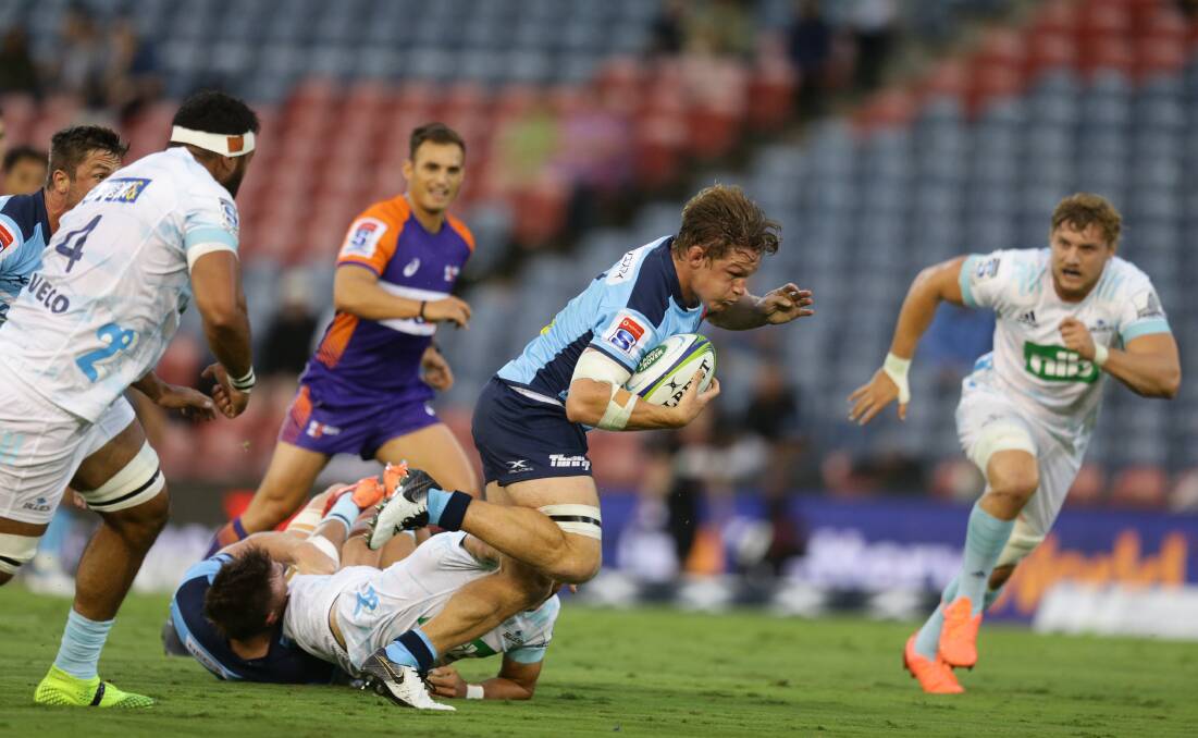 ON THE CHARGE: Waratahs breakaway Michael Hooper breaks out of a tackle in the loss to the Auckland Blues at McDonald Jones Stadium on Saturday night. Picture: Jonathan Carroll 