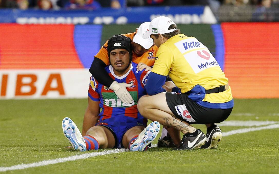 Sore: Knights centre Sione Mata'utia is treated on the field before being assisted off late in the win over Parramatta on Friday night. He has had precautionary scans on a possible eye socket fracture. Picture: Darren Pateman/AAP
