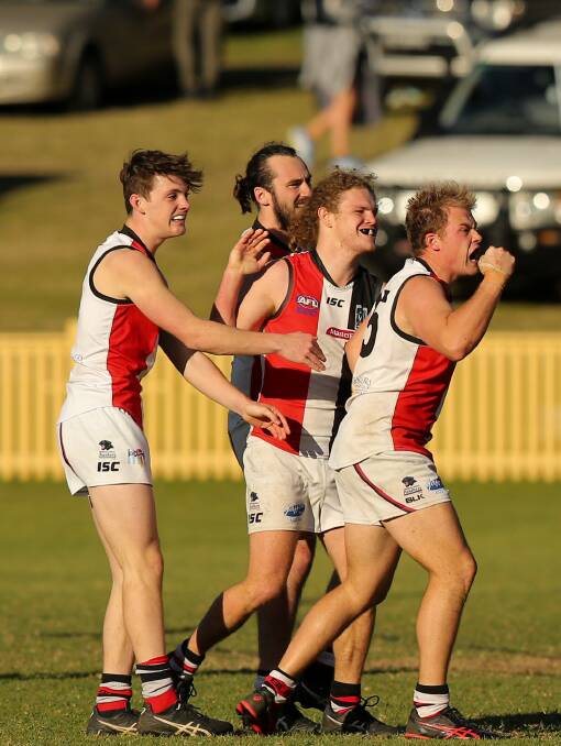 PARTY TIME: Terrigal Avoca celebrate after kicking a goal in the win against City. Picture: Max Mason-Hubers