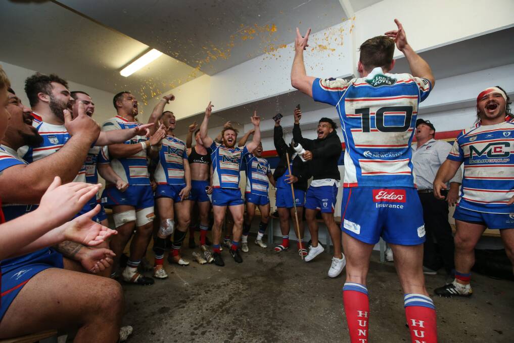 PARTY MODE: The Hunter Wildfires sing the team song in the sheds after the win over Sydney University. Picture: Marina Neil