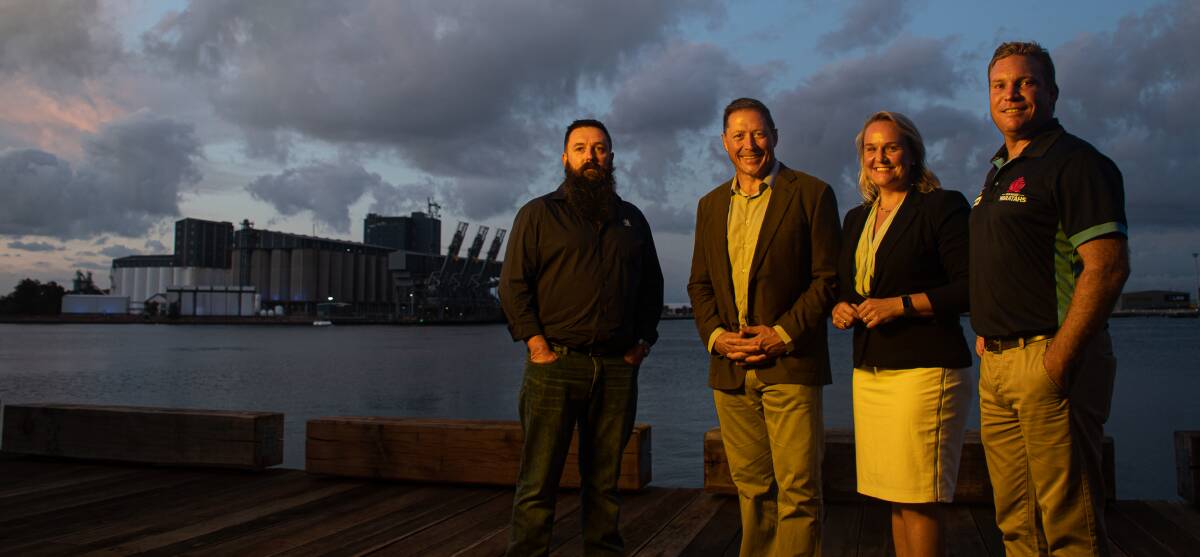 UP IN LIGHTS: Jade Mann (Graincorp), Phil Kearns (Venues NSW), Nuatali Nelmes (City of Newcastle Lord Mayor) and Tim Rapp (NSW Rugby Union) at Newcastle harbour for the lighting of silos in blue to promote the Super Rugby clash on Saturday. Picture: Simon McCarthy 