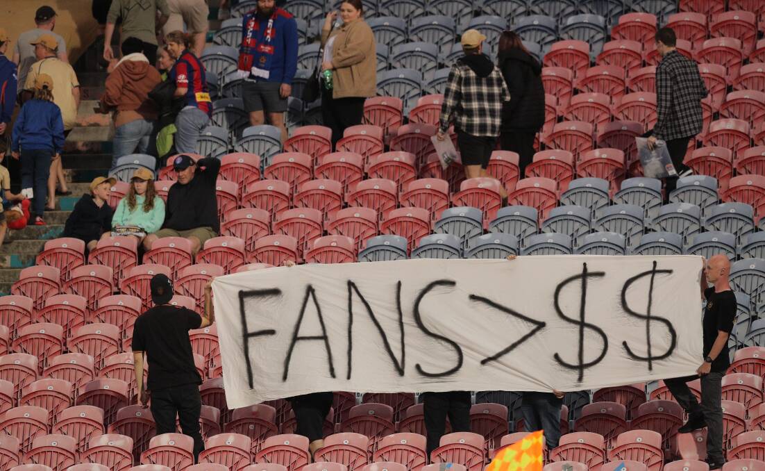 Newcastle Jets fans voiced their disapproval of the Australian Professional League's decision to sell the grand final to Sydney for the next three seasons by walking out after 20 minutes. Picture by Max Mason-Hubers. 
