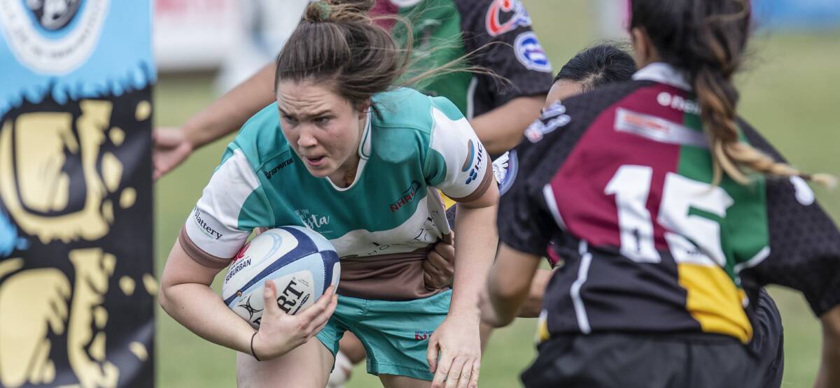 ON THE RISE: Ashleigh Walker crashes over for a try for the Hunter Wildfires. The powerhouse inside centre will attend a Wallaroos training camp in Canberra next week. Picture: Stewart Hazell