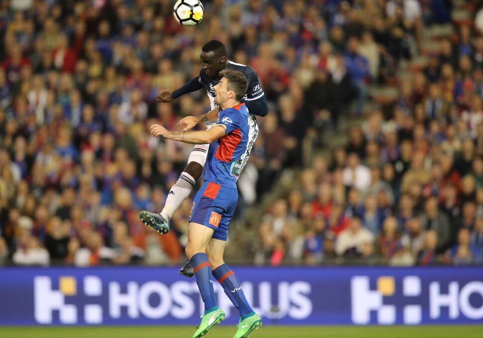 Jets fullback Jason Hoffman competes for a header against Melbourne Victory's Thomas Deng in the 2018 grand final at McDonald Jones Stadium. Picture by Jonathan Carroll