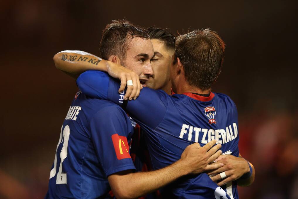 MATCH-WINNER: Angus Thurgate is congratulated by Nick Fitzgerald and Dimi Petratos after scoring a goal in the Jets 2-0 triumph over Western Sydney at McDonad Jones Stadium on Saturday night. Picture: Getty Images