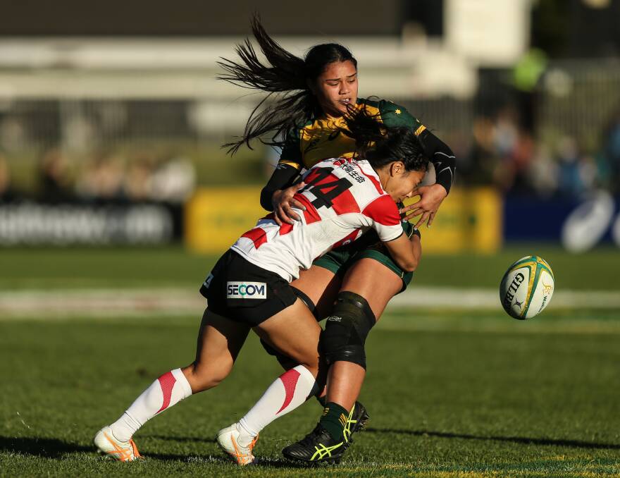 CENTRE OF ATTENTION: Exciting prospect Alysia Lefua-Fakaosilea is hit by a solid tackle from Japanese winger Eriko Hirano. Picture: Marina Neil
