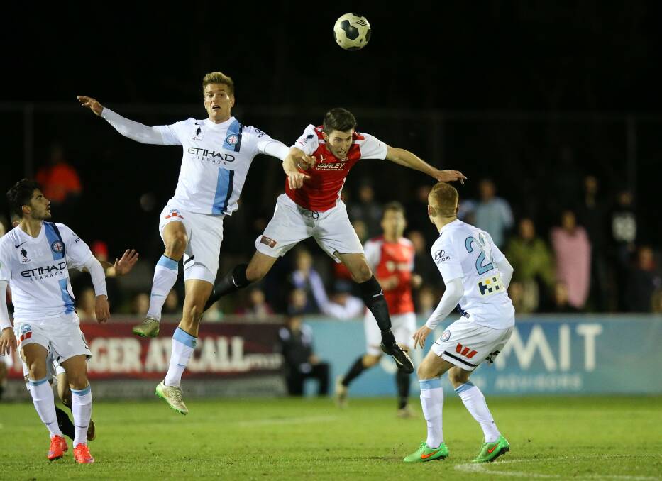 CUP MAGIC: Melbourne City's Erik Paartalu and Edgeworth's Brenton Olzomer compete for a header in the FFA Cup round-of-32 clash in 2015. Picture: Max Mason-Hubers