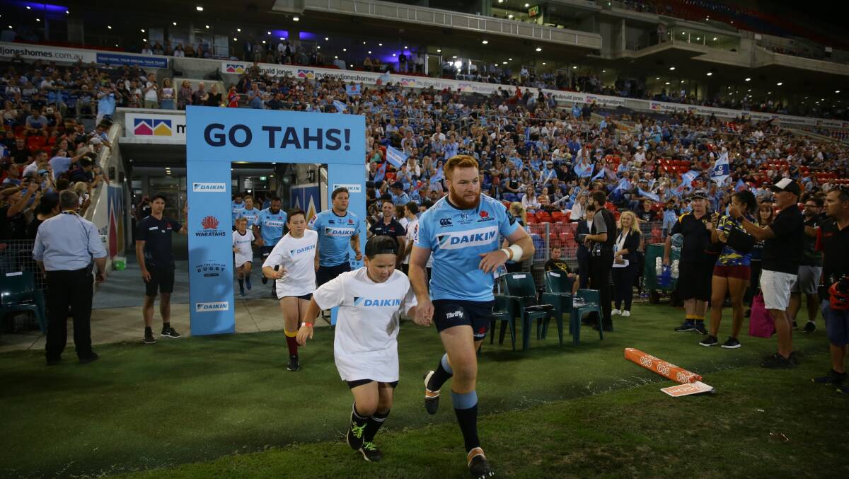 SHOW TIME: Newcastle prop Harry Johnson-Holmes runs out on to McDonald Jones Stadium for the Tahs clash against the Sunwolves in March. Picture: Jonathan Carroll