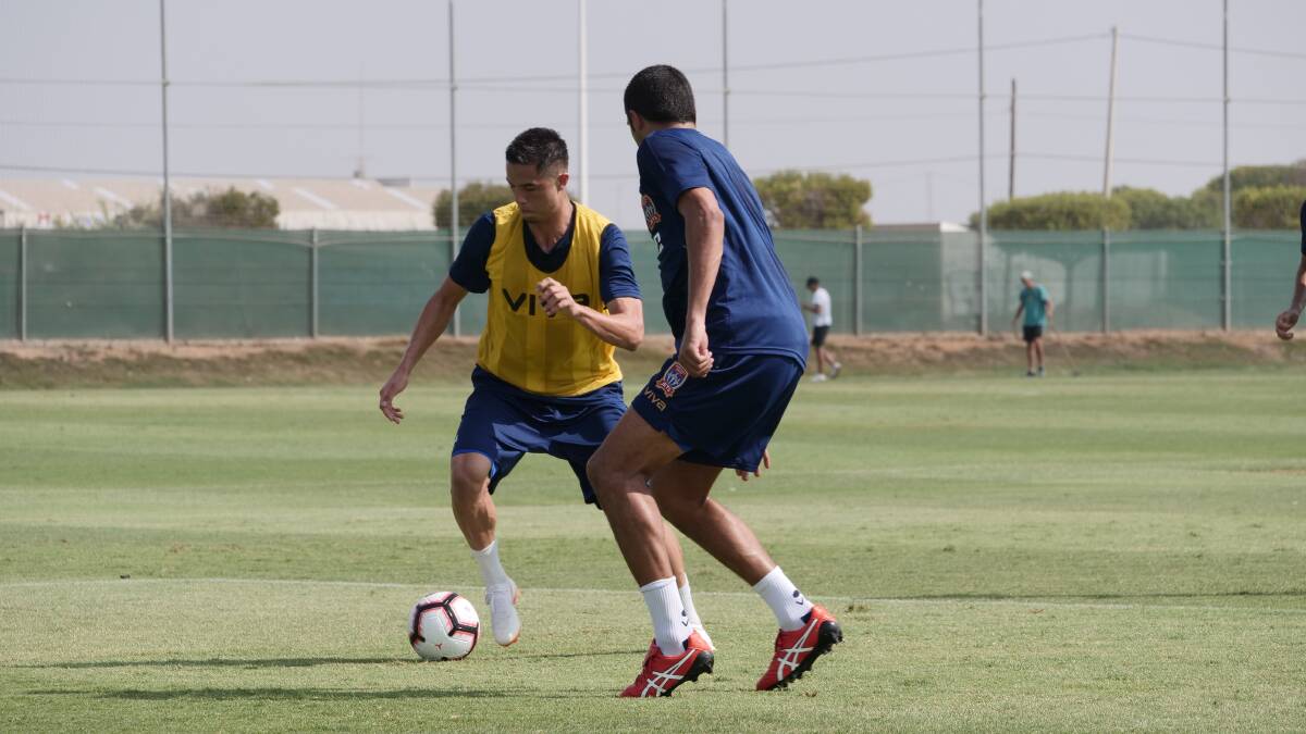 ON THE BALL: Joe Champness is marked by Nikolai Topor-Stanley during a drill at the Jets training camp in Spain. 