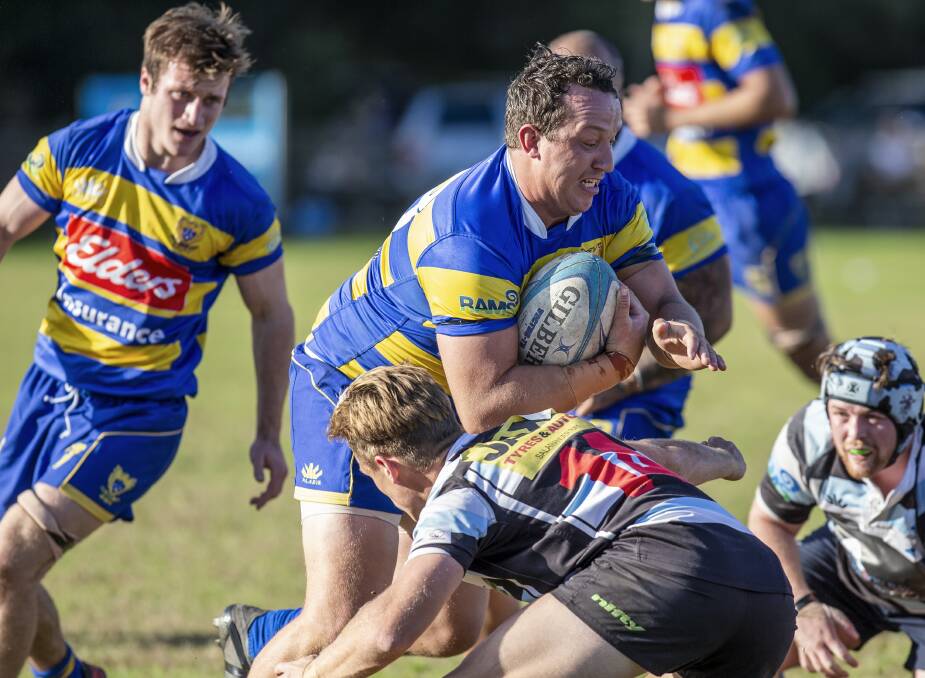 ON THE CHARGE: Hamilton centre Bill Clay crashes into a Nelson Bay tackler in the Hawks' win on Saturday. Picture: Stewart Hazell