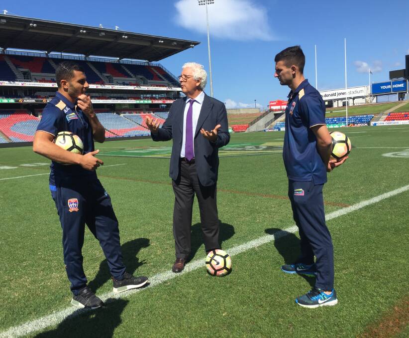 FRIENDLY CHAT: Newcastle Jets winger Andrew Nabbout and midfielder Steve Ugarkovics with Chilean Consul-General to Australia Humberto Molina at McDonald Jones Stadium on Tuesday.
