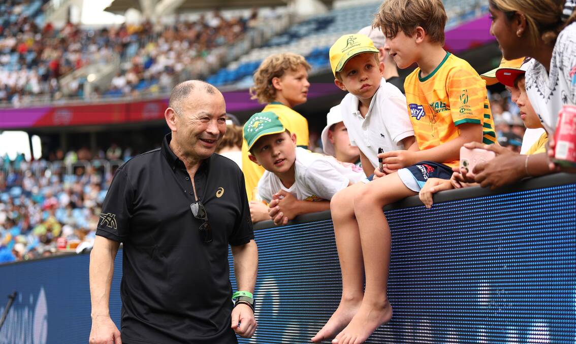 New Wallabies coach Eddie Jones talks with young fans at the IRB Sevens tournament in Sydney last weekend. Jones will be the special guest at the Hunter Rugby Union season launch on March 31. Picture Getty Images 