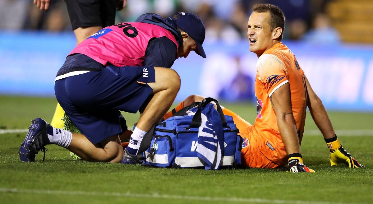 PAIN BARRIER: Glen Moss receives treatment to his knee in the 4-1 loss to Sydney FC. Picture: Getty Images