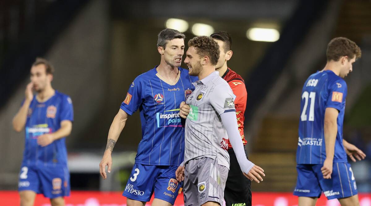 SPICE: Jason Hoffman squares up against Mariners midfielder Gianni Stensness at McDonald Jones Stadium on Saturday night. Picture: Ashley Feder (Getty Images)