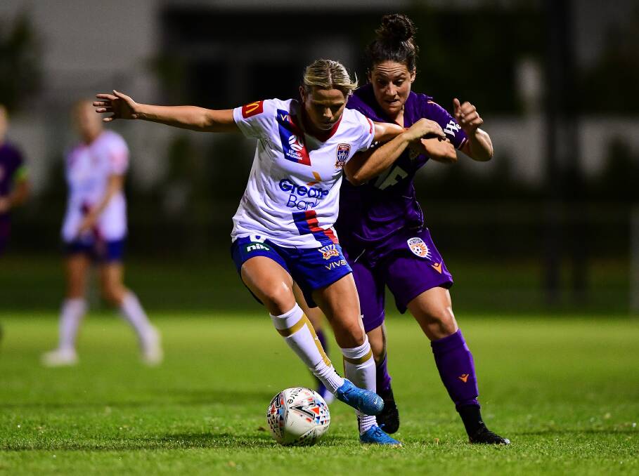 STRONG EFFORT: Jets centre-back and co-captain Cassidy Davis competes for the ball with Perth's Katarina Jukic in Newcastle's 2-1 win last round. PIcture: Getty Images