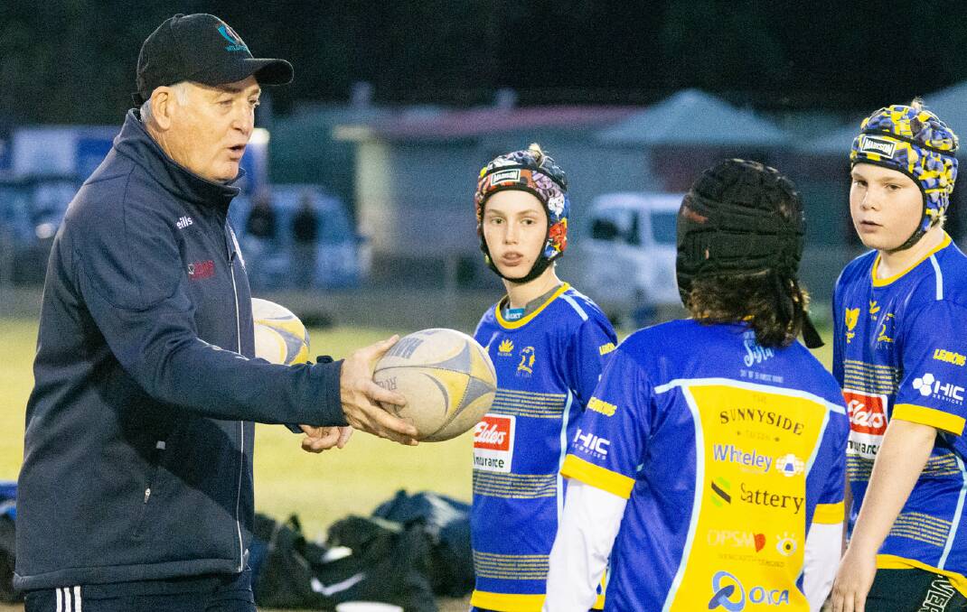 RUNNING GAME: Wallabies great and Hunter Juniors ambassador David Campese gives instructions to Hamilton players at training. Picture: Pat Gleeson