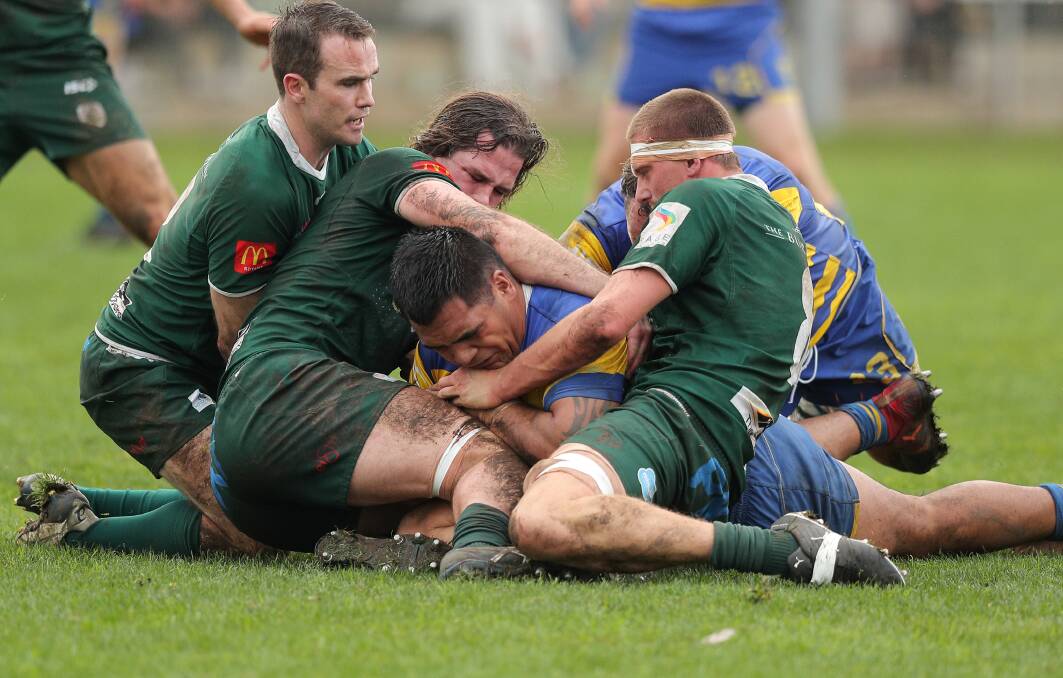 Darcy Chirstie-Johnston and lachy Miler try to hold up Hamilton prop Chris Hemi. Christie-Johnston returns from suspension for the Greens in the major semi-final against the Hawks on Saturday. Picture by Stewart Hazell 