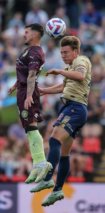 Newcastle Jets defender James McGarry wins a header. Picture by Marina Neil 