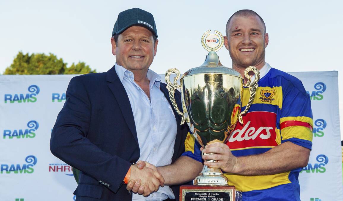 ON HOLD: NHRU president Bill Clifton presents the premiership cup to Steve Lamont. Picture: Stewart Hazell