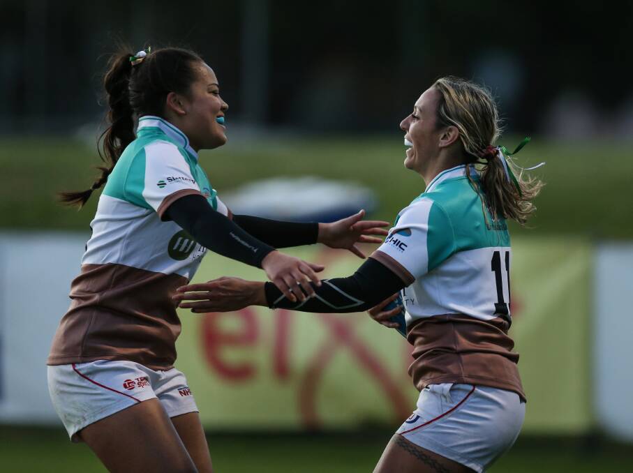 DYNAMIC DUO: Fullback Sian Filipo celebrates with Anika Butler after the winger scored her third try in a 53-0 romp over Gordon. Picture: Marina Neil
