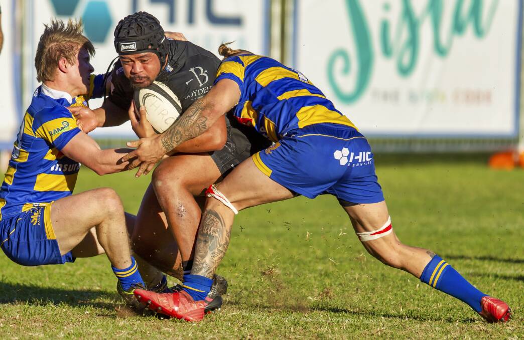 HEAD ON: Maitland hooker Phil Bradford is met by two Hamilton defenders in the Blacks' 34-21 loss to the Hawks at Passmore Oval on Saturday. Pictures: Stewart Hazell