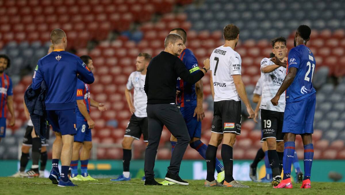 ON HOLD: Newcastle players and staff bump elbows with Melbourne City players after the Jets' 2-1 win last month. Picture: Getty Images 